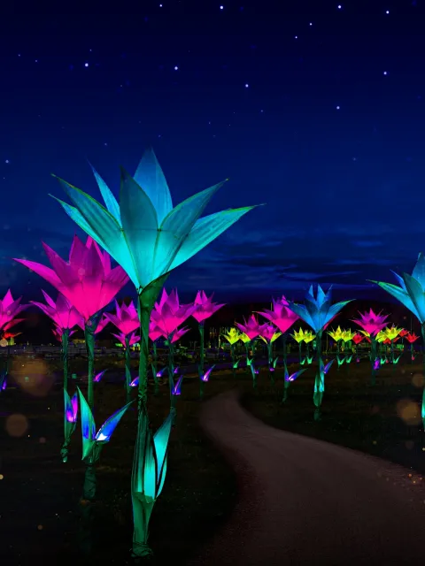 Leuchtende bunte Blüten in einer nächtlichen Gartenlandschaft unter Sternenhimmel